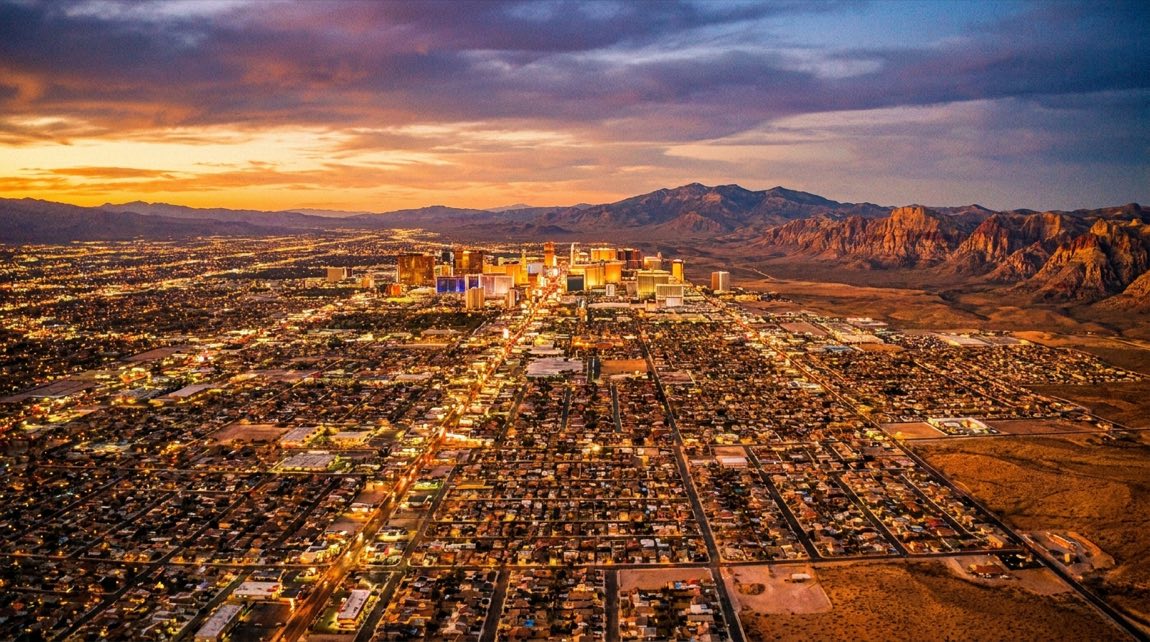 A sweeping golden-hour aerial of the Las Vegas valley